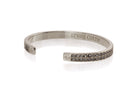 Pave  2 rows C.Z.in center of this beautiful 1/4" cuff bracelet signature logos on outside of each end .Silver plated 